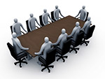 People sitting around a table at a board meeting.